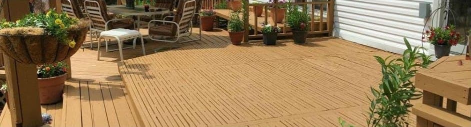 Refinished deck with an even warm stain, furniture, and planters