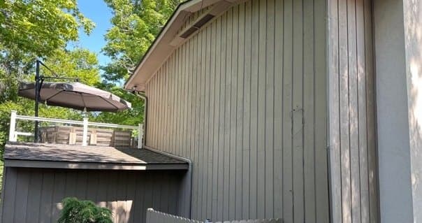 Gable end of vertical wood siding near the upper deck, after