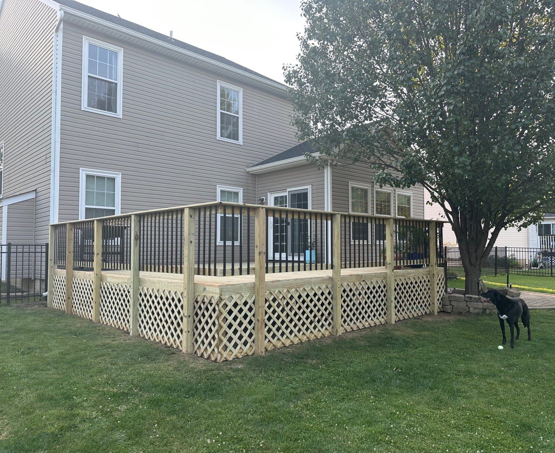 Bare wood deck with lattice skirting, before staining