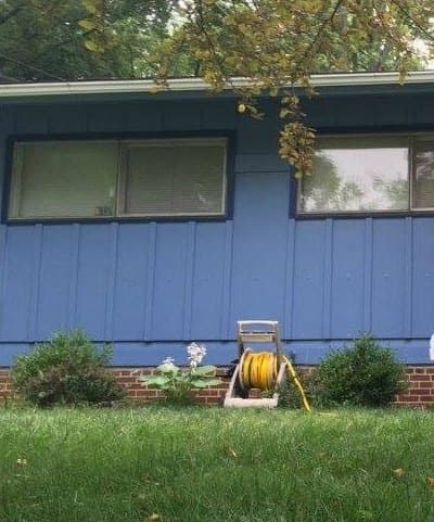 Front of the ranch home with blue siding, after