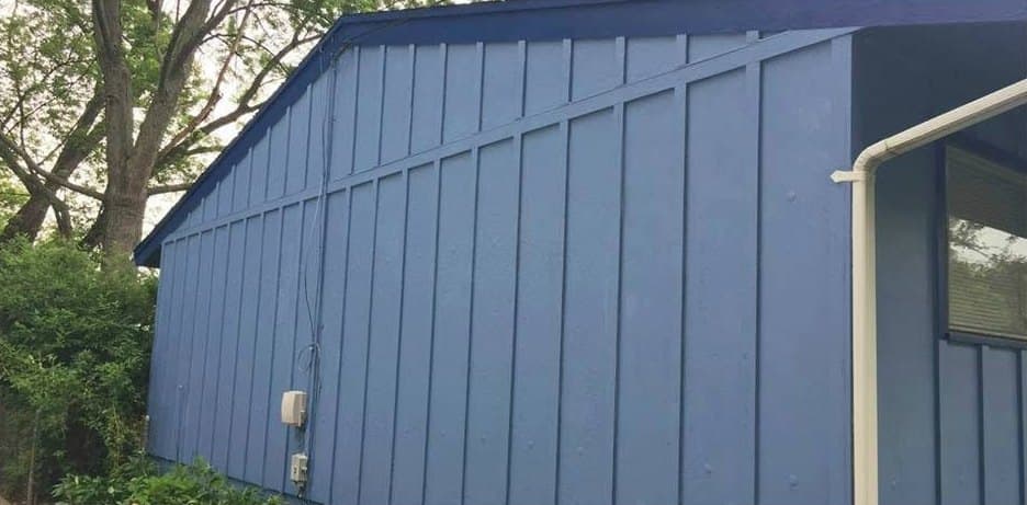 The same siding prepped and repainted blue, after