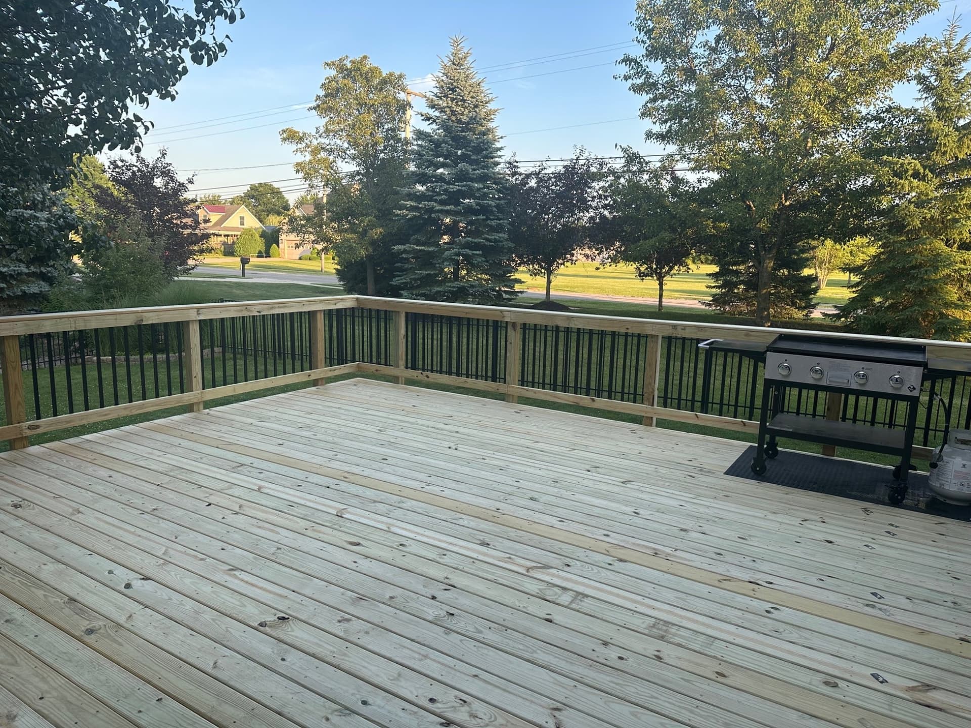 Bare wood deck boards and railing, before staining